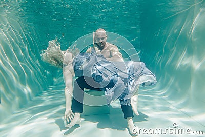Beautiful romantic couple of lovers hugging gently under water Stock Photo