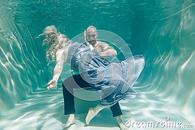 Beautiful romantic couple of lovers hugging gently under water Stock Photo