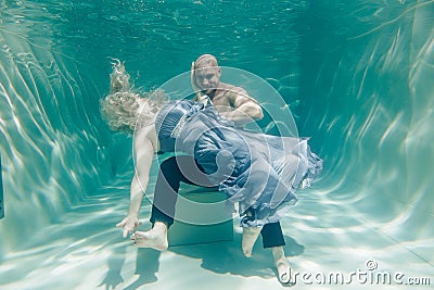 Beautiful romantic couple of lovers hugging gently under water Stock Photo