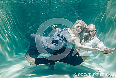 Beautiful romantic couple of lovers hugging gently under water Stock Photo