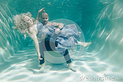 Beautiful romantic couple of lovers hugging gently under water Stock Photo