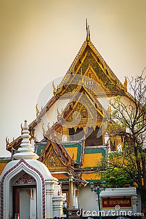 Beautiful roof gable and entrance gate of Wat Suthat temple, Thailand. Wat Suthat Thepphawararam is a royal temple of the first g Stock Photo