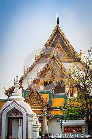 Beautiful roof gable and entrance gate of Wat Suthat temple, Thailand. Wat Suthat Thepphawararam is a royal temple of the first g Stock Photo