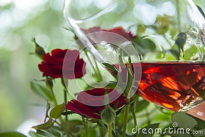 Beautiful rose glass of wine with roses on blurred background. Valentine`s Day. Mothers Day. Romantic gift. Love. Stock Photo