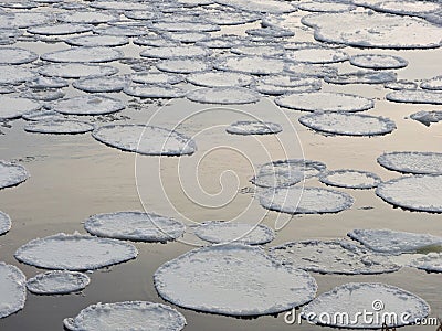 White round ice pieces on river current, Lithuania Stock Photo