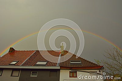 Beautiful rainbow and ordinary roofs Stock Photo