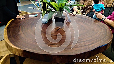 Beautiful round wooden dinner table displaysed in shopping mall Stock Photo