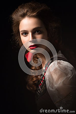 Beautiful Russian girl in national dress with a braid hairstyle and red lips. Beauty face. Stock Photo