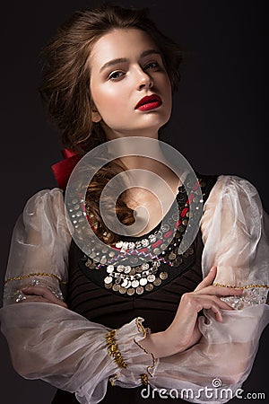 Beautiful Russian girl in national dress with a braid hairstyle and red lips. Beauty face. Stock Photo