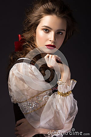 Beautiful Russian girl in national dress with a braid hairstyle and red lips. Beauty face. Stock Photo