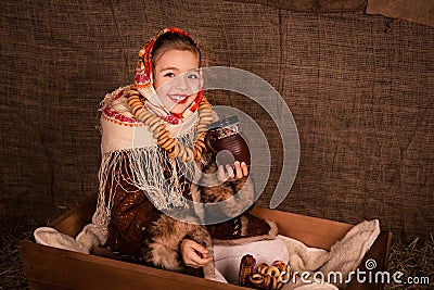 Beautiful russian girl in a shawl sitting in a cart Stock Photo