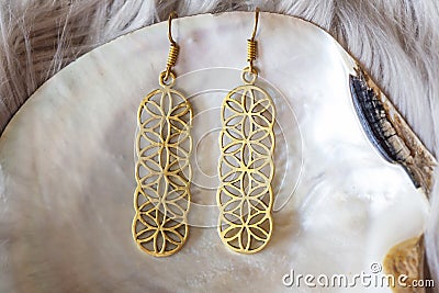 Beautiful sacred geometry brass earrings Stock Photo