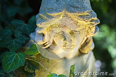 Beautiful sad angel. Vintage styled image of ancient statue. Fragment of sculpture. Selective focus Stock Photo
