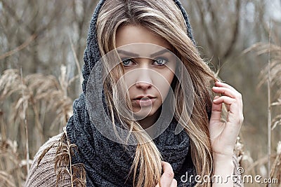 beautiful sad girl is walking in the field. Photo in brown tones. Stock Photo