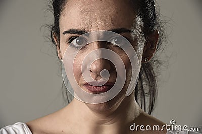 Beautiful and sad woman crying desperate and depressed with tears on her eyes suffering pain Stock Photo