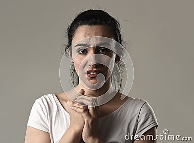 Beautiful and sad woman crying desperate and depressed with tears on her eyes suffering pain Stock Photo