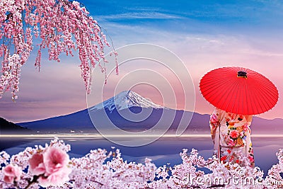 Sakura at Mount Fuji and Kawaguchiko Lake in Japan. A girl wearing a yukata with a red umbrella. Stock Photo