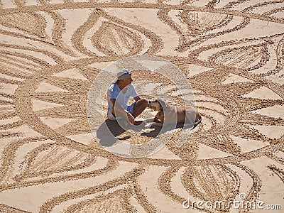 Beautiful sand mandala with its artist named Vitor Raposo Editorial Stock Photo