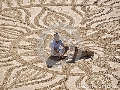 Beautiful sand mandala with its artist named Vitor Raposo Editorial Stock Photo