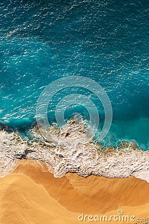 Beautiful sandy beach with blue sea, vertical view. Drone view of tropical blue ocean beach Nusa penida Bali Indonesia. Stock Photo