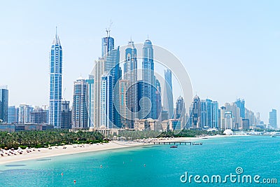 Beautiful Sandy Beach and Modern Metropolitan Skyline Stock Photo