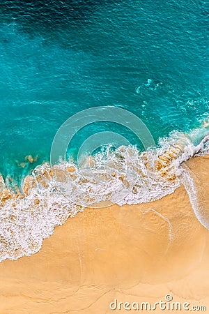 Beautiful sandy beach with turquoise sea, vertical view. Drone view of tropical turquoise ocean beach Nusa penida Bali Indonesia. Stock Photo