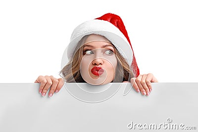 Beautiful Santa girl peeping out of blank banner on background. Christmas celebration Stock Photo