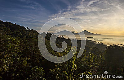 Beautiful Scene of Merapi Merbabu Mountain at Sunrise time from Punthuk Setumbu. Stock Photo