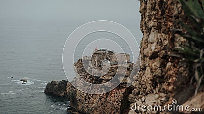 Beautiful scene of the rocky Fort of Sao Miguel Arcanjo by sea in Portugal at sunset Stock Photo