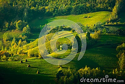 Beautiful scenery landscape Romania Holbav village mountains hills fields foggy morning Stock Photo