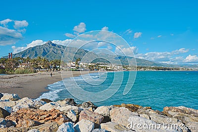 Beautiful scenery of people by the sand in Marbella, Spain Editorial Stock Photo