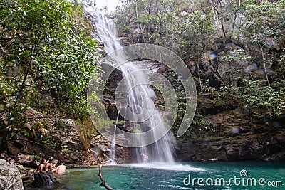 Beautiful scenery of a waterfall flowing into the river in the middle of a rock formation Editorial Stock Photo