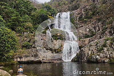 Beautiful scenery of a waterfall flowing into the river in the middle of a rock formation Editorial Stock Photo