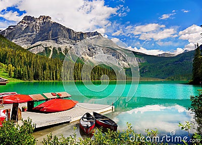 Scenic green lake boats mountains landscape Stock Photo