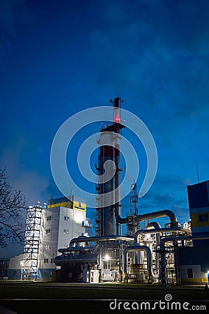 Beautiful scenic of petrochemical oil refinery plant shines with red and white lights at night with and copy space vertical Stock Photo