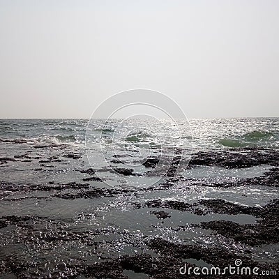 Beautiful sea and dangerous sharp sea rocks image in sunset india Stock Photo