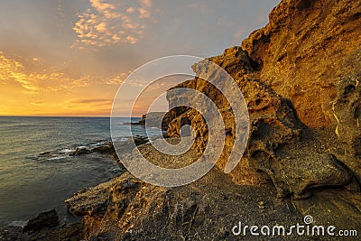 Beautiful sea landscape - sunset over a rocky ocean cliff.Punta Papagayo Stock Photo