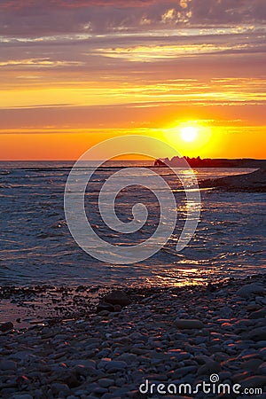 Beautiful sea sunset on stony seashore Stock Photo