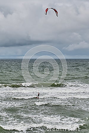 Beautiful seascape with kitesurfer, riding waves. Editorial Stock Photo