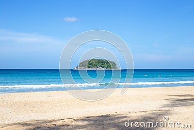 Beautiful seascape. Small round island in the sea covered with tropical greenery, blue sky on the horizon.Travel and Stock Photo