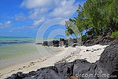 Beautiful secluded Beach surrounded with Black Rocks at Ile aux Cerfs Mauritius Stock Photo