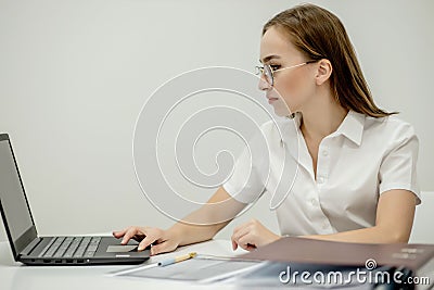 Beautiful secretary in spectacles is checking her boss is meeting to arrange another one. She is friendly and smiling Stock Photo