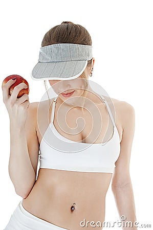 Beautiful seductive female tennis player with red apple. Stock Photo