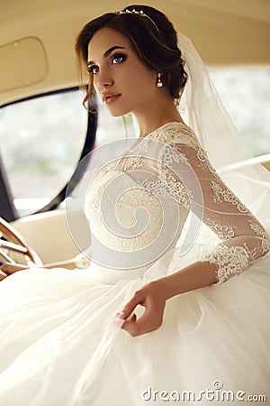 Beautiful sensual bride with dark hair in luxurious lace wedding dress Stock Photo
