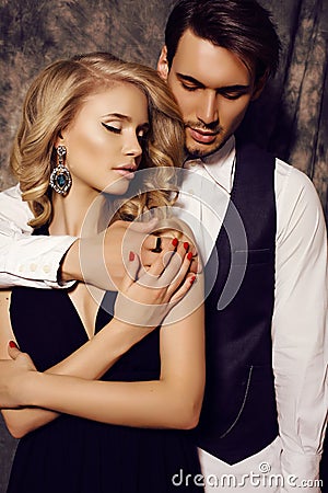 Beautiful sensual couple in elegant clothes posing in studio Stock Photo