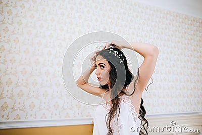 Beautiful sensual young bride in bedroom. Last preparations for the wedding. Bride waits for her groom. Wedding morning Stock Photo