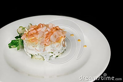 Beautiful serving dish salad under the crooks and garnished with herbs on a white plate food restaurant on a black background Stock Photo
