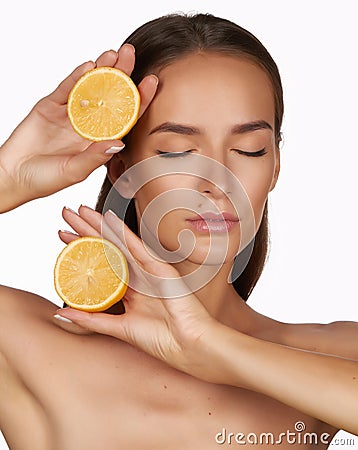 Beautiful brunette woman with citrus on a white background, healthy food, tasty food, organic diet, smile healthy Stock Photo