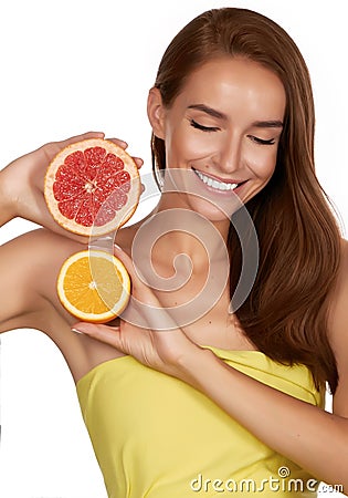 Beautiful brunette woman with citrus on a white background, healthy food, tasty food, organic diet, smile healthy Stock Photo