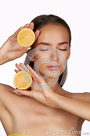 Beautiful brunette woman with citrus on a white background, healthy food, tasty food, organic diet, smile healthy Stock Photo